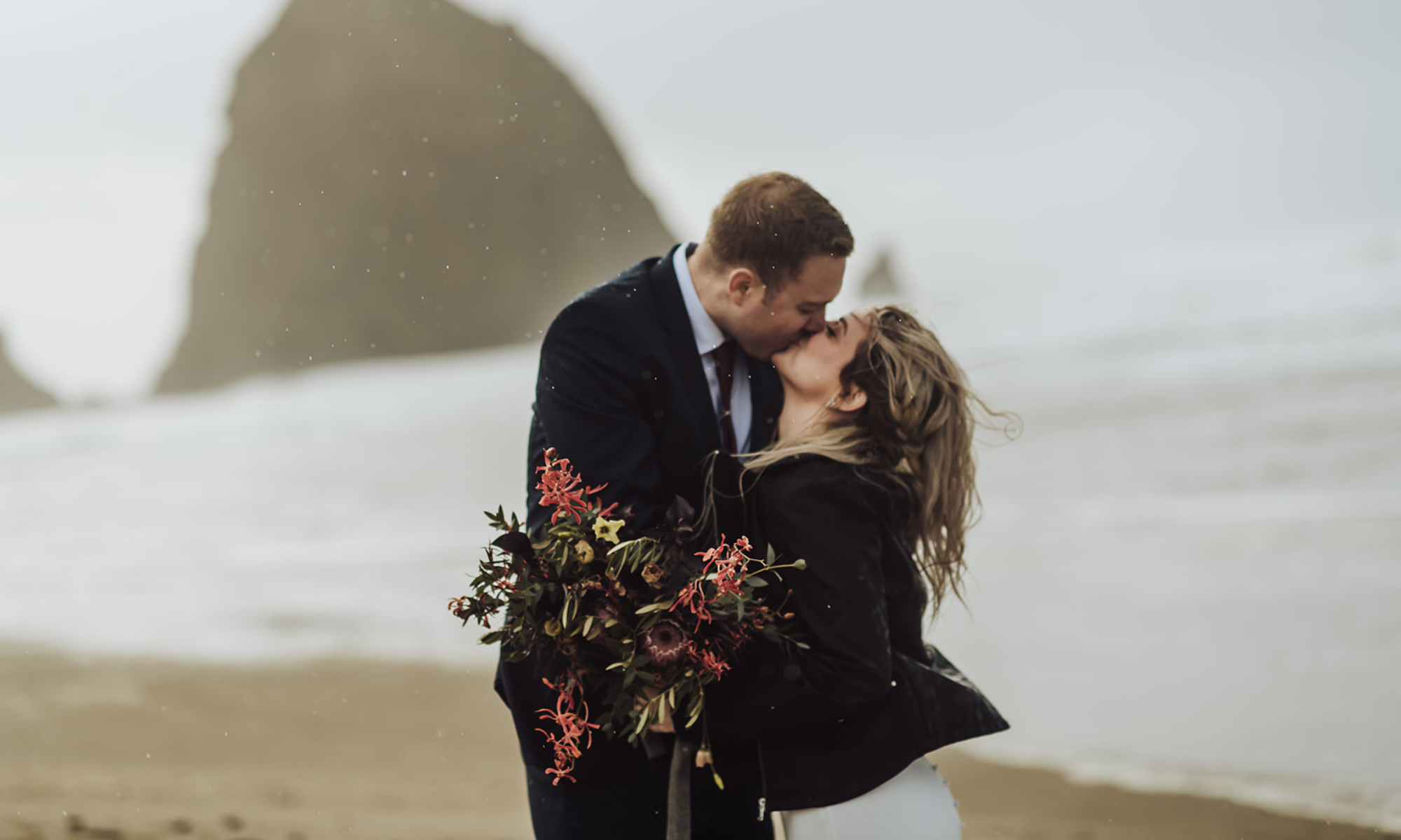 Bride and groom kissing on the beach